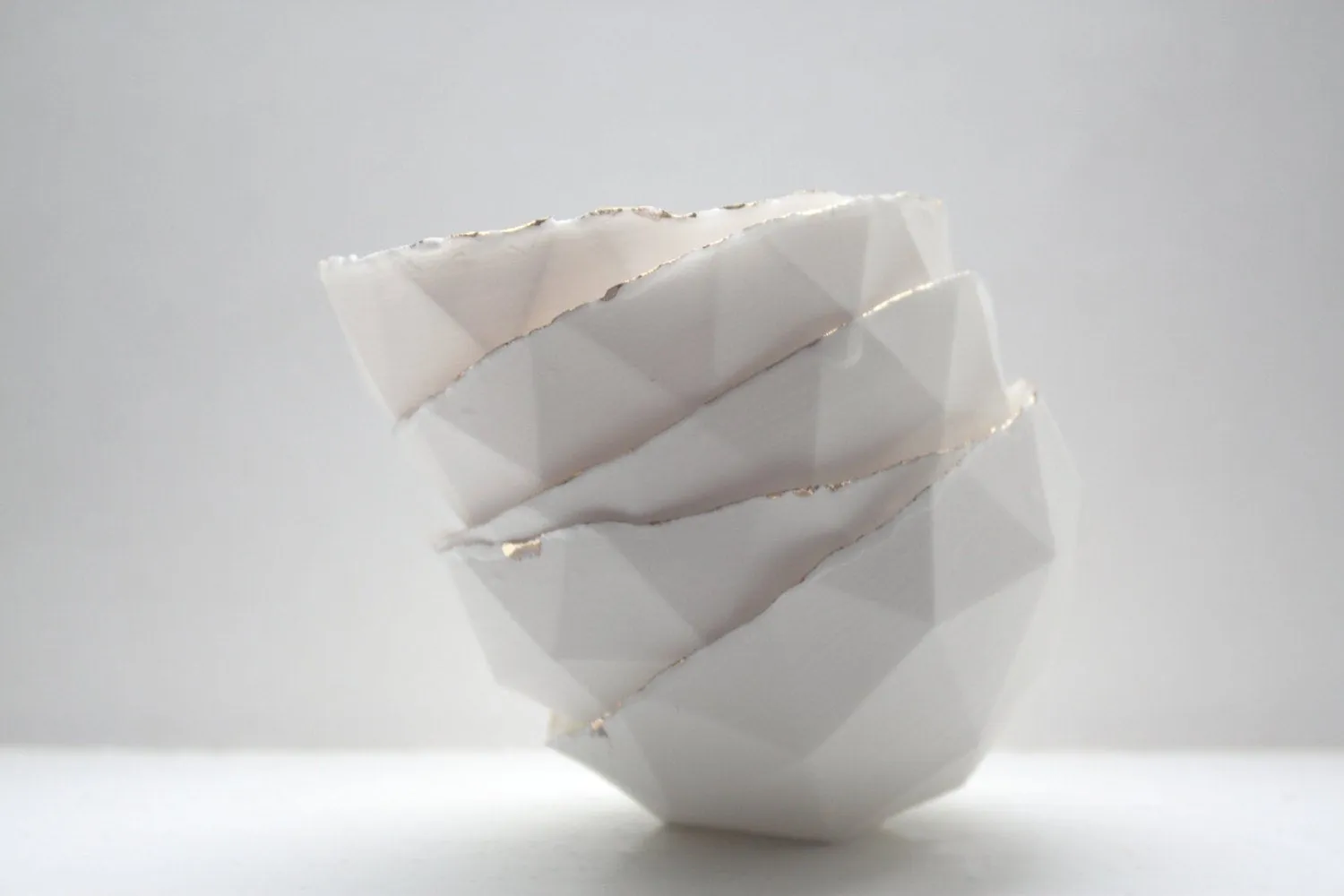 Geometric faceted polyhedron white bowl made from stoneware Parian porcelain with real gold finish