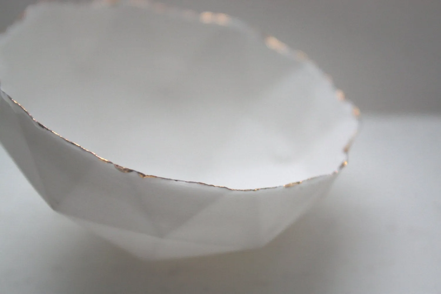 Geometric faceted polyhedron white bowl made from stoneware Parian porcelain with real gold finish