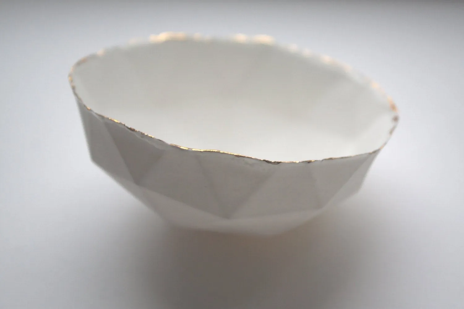 Geometric faceted polyhedron white bowl made from stoneware Parian porcelain with real gold finish